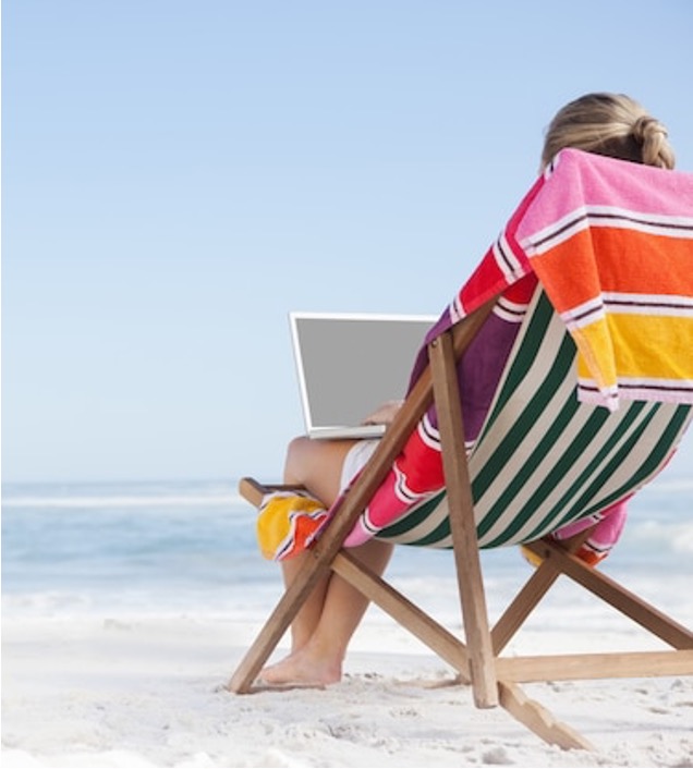 Work vacation A person sitting in a beach chair with a laptop